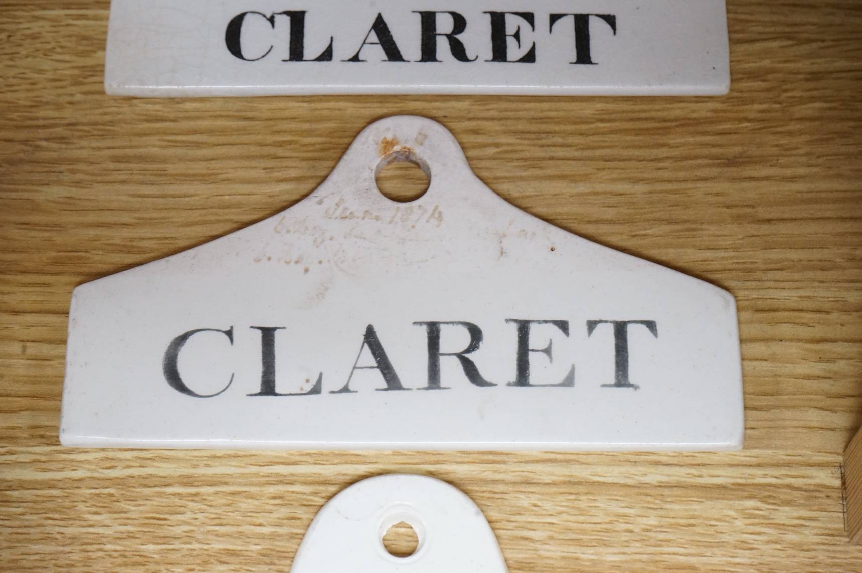 Two Creamware Claret labels, 14.4cm wide and a similar Sherry label, c.1820